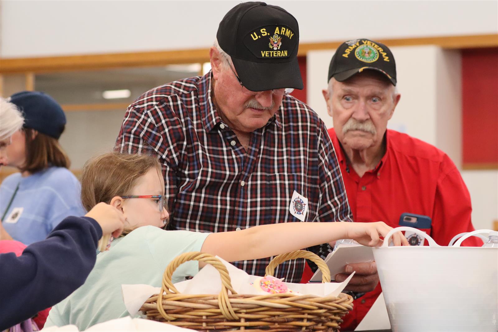 Image of U.S Army veteran working looking at a piece of paper with a student